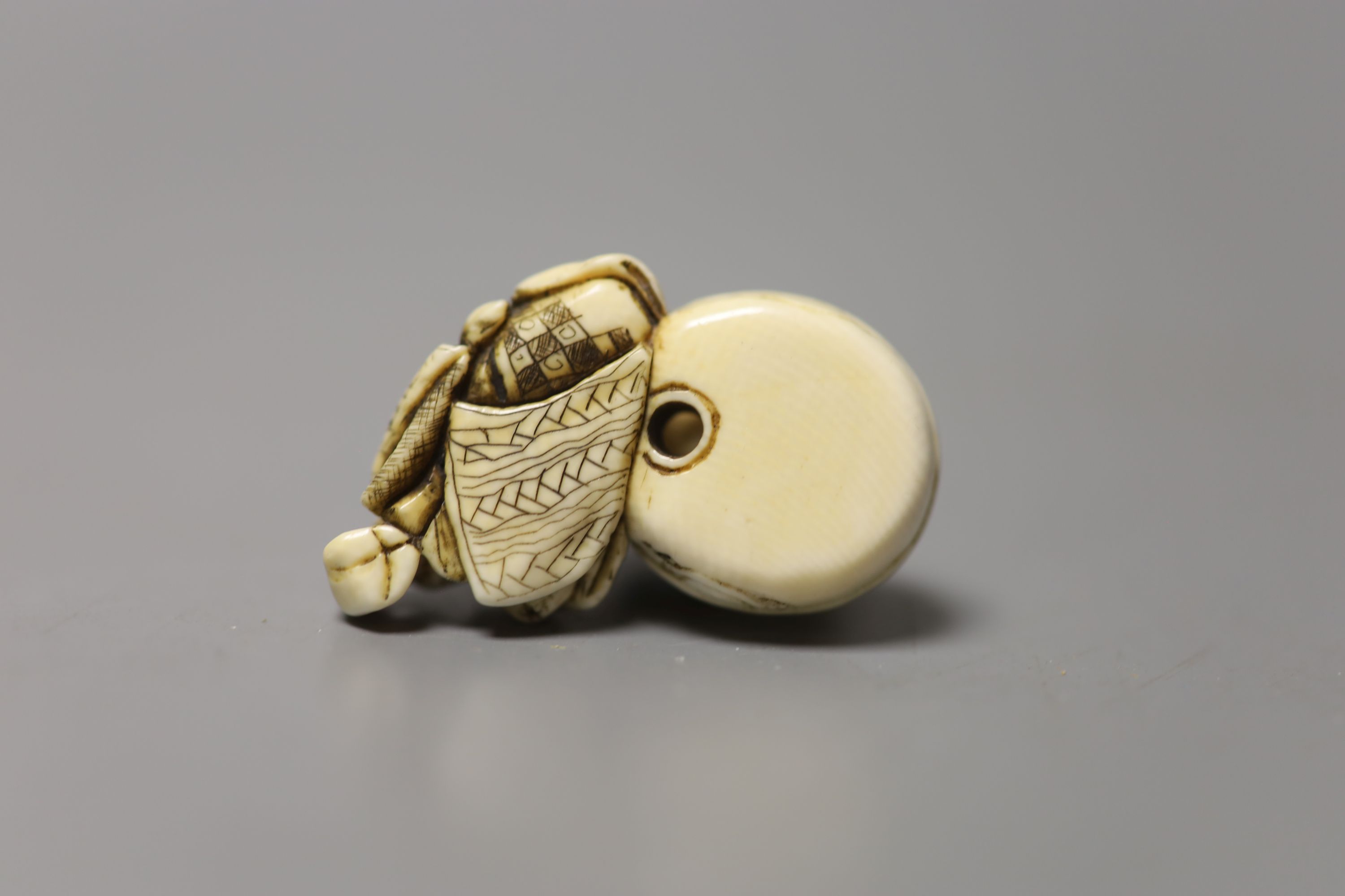 A 19th century Japanese ivory netsuke of a woman washing her hair, 3.5cm wide